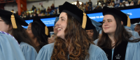 Female graduate sitting in a crow at graduation